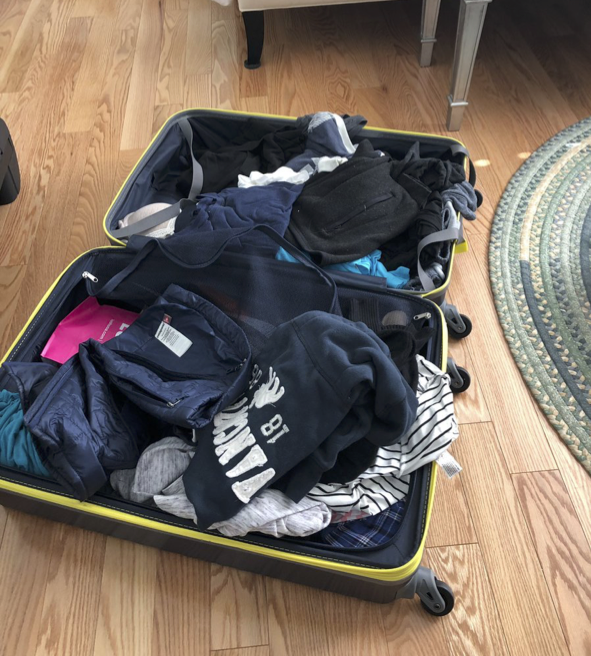 an open suitcase full of clothes
